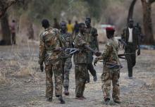 Rebel fighters greet one another in a rebel camp in Jonglei State