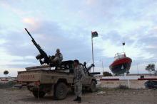 Rebels under Ibrahim Jathran, a former anti-Gaddafi rebel who seized the port and two others with thousands of his men in August, stand guard at the entrance of the Es Sider export terminal where a North Korean-flagged tanker has docked in Ras Lanuf