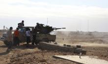 Libyan Army Forces belonging to Libya's rival government, that are part of the Alshorooq (Libya Dawn) operation to free oil ports, fire a vehicle-mounted weapon on the outskirts of Al Sidra oil port, December 14 2014. PHOTO BY REUTERS/Stringer