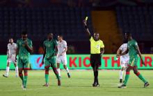 Mauritania's Moctar Sidi El Hacen is shown a yellow card by referee Louis Hakizimana. PHOTO BY REUTERS/Suhaib Salem