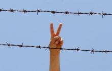 A Syrian flashes V-sign at a refugee camp in the Turkish border town of Altinozu in Hatay province, June 17, 2011. PHOTO BY REUTERS/Umit Bektas