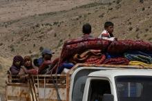 Syrian Refugees seen on the back of a truck at Lebanon's border region of Arsal, Lebanon, July 12, 2017. PHOTO BY REUTERS/Hassan Abdallah