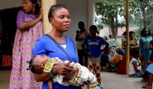 A still image taken from a video shot on December 9, 2017 shows a Cameroonian refugee woman carrying a child outside a center in Agbokim Waterfalls village, which borders on Cameroon, Nigeria. PHOTO BY REUTERS