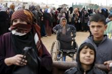 Syrian refugees stand in line as they wait for aid packages at Al Zaatari refugee camp in the Jordanian city of Mafraq, near the border with Syria, January 20, 2016. PHOTO BY REUTERS/ Muhammad Hamed