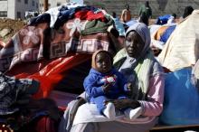 Sudanese refugees from Darfur sit near their tent in an open-ended sit-in outside the United Nations High Commissioner for Refugees (UNHCR) office, demanding better treatment and acceleration of their relocation, in Amman, Jordan, December 11, 2015. PHOTO BY REUTERS/Muhammad Hamed