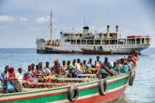 Refugees from Burundi who fled the ongoing violence and political tension sail on a boat to reach MV Liemba, a ship freighted by the United Nations at the Kagunga landing base on the shores of Lake Tanganyika near Kigoma in Tanzania, May 26, 2015. PHOTO BY REUTERS/Sala Lewis