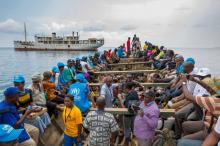 Refugees from Burundi who fled the ongoing violence and political tension and aid workers sail on a boat to reach MV Liemba, a ship freighted by the United Nations at the Kagunga landing base on the shores of Lake Tanganyika near Kigoma in Tanzania, in this May 26, 2015 handout photo by PLAN INTERNATIONAL. PHOTO BY REUTERS