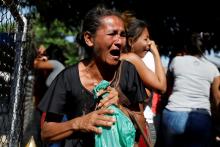 Relatives of inmates at the General Command of the Carabobo Police react as they wait outside the prison in Valencia, Venezuela, March 28, 2018. PHOTO BY REUTERS/Carlos Garcia Rawlins