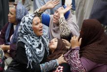 Relatives and families of members of Muslim Brotherhood and supporters of ousted President Mohamed Mursi react after hearing the sentence, in front of the court in Minya, south of Cairo