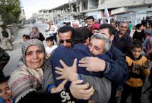 Relatives hug one of the hostages held by Islamic State militants who escaped from his captors in Qaryatayn town in Homs province, Syria, October 29, 2017. PHOTO BY REUTERS/Omar Sanadiki