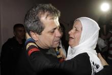 Released Palestinian prisoner Moayyad Hajji, 46, who was arrested in 1992, hugs his sister upon his arrival at his family's house