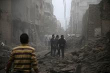 Residents inspect damage from what activists said was an airstrike by forces loyal to Syria's President Bashar al-Assad on the main field hospital in the town of Douma, eastern Ghouta in Damascus, October 29, 2015. PHOTO BY REUTERS/Bassam Khabieh