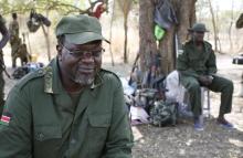 South Sudan's rebel leader Riek Machar sits near his men in a rebel-controlled territory in Jonglei State