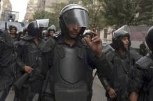 Riot police take their positions as protesters and activists called for demonstrations on the third anniversary of the Mohamed Mahmoud violent clashes in central Cairo, November 19, 2014. PHOTO BY REUTERS/Asmaa Waguih