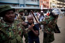 Riot policemen detain a man during clashes between supporters of Kenya's President Uhuru Kenyatta and supporters of Kenyan opposition National Super Alliance (NASA) coalition, during a protest in Nairobi, Kenya, October 11, 2017. PHOTO BY REUTERS/Baz Ratner