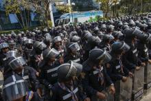 Riot police officers stand guard inside the compound of the Thai Royal Police club in Bangkok