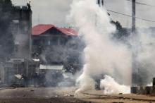 Riot police are seen behind a cloud of tear gas in the Democratic Republic of Congoin a file photo. PHOTO BY REUTERS/Emmanuel Braun