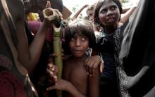 A Rohingya refugee girl reacts as people scuffle while waiting to receive aid in Cox's Bazar, Bangladesh, September 25, 2017. PHOTO BY REUTERS/Cathal McNaughton