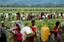 Rohingya refugees, who crossed the border from Myanmar two days before, walk after they received permission from the Bangladeshi army to continue on to the refugee camps, in Palang Khali, near Cox's Bazar, Bangladesh, October 19, 2017. PHOTO BY REUTERS/Jorge Silva