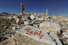 Graffiti sprayed by Islamic State militants which reads "We remain" is seen on a stone at the Temple of Bel in the historic city of Palmyra, in Homs Governorate, Syria, April 1, 2016. PHOTO BY REUTERS/Omar Sanadik