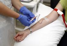 Volunteer Ruth Atkins has blood taken before receiving an injection of the Ebola vaccine at the Oxford Vaccine Group Centre for Clinical Vaccinology and Tropical Medicine (CCVTM) in Oxford, southern England, September 17, 2014. PHOTO BY REUTERS/Steve Parsons