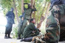 Sudan People's Liberation Army (SPLA) soldiers rest in the shade as they take a break from guarding Stephen Dhieu Dau, South Sudan's minister of petroleum, and his delegation during their visit to Paloch, Upper Nile State