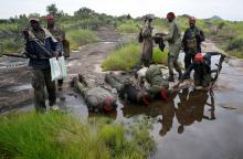 SPLA-IO (SPLA-In Opposition) rebels drink water from a pond after an assault on government SPLA (Sudan People's Liberation Army) soldiers near the town of Kaya, on the border with Uganda, South Sudan, August 26, 2017. PHOTO BY REUTERS/Goran Tomasevic