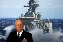 Commander of the U.S. Pacific Fleet Admiral Scott Swift sits in front of a large poster of an Australian Navy frigate as he speaks during a media conference at the 2015 Pacific International Maratime Exposition in Sydney, Australia, October 6, 2015. PHOTO BY REUTERS/David Gray