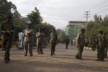 Security officers stand guard after a news conference by Kenyan government officials near the Westgate shopping mall in Nairobi