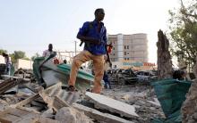 A security officer from Doorbin Hotel assesses the debris after a suicide car explosion in front of the hotel in Mogadishu, Somalia, February 24, 2018. PHOTO BY REUTERS/Feisal Omar