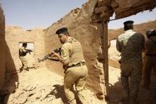 Members of Iraqi security forces take their positions during a patrol looking for militants of the Islamic State of Iraq and the Levant (ISIL) west of Kerbala