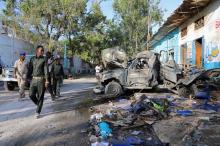 Somali security officers assess the scene of a suicide car bomb explosion, at the gate of Naso Hablod Two Hotel in Hamarweyne district of Mogadishu, Somalia, October 29, 2017. PHOTO BY REUTERS/Feisal Omar