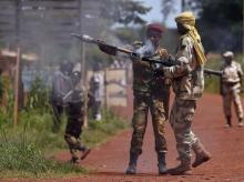 A Seleka fighter prepares a rocket propelled grenade (RPG) to be fired towards French troops in Bambari, May 24, 2014. PHOTO BY REUTERS/Goran Tomasevic