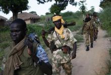 Seleka fighters patrol as they search for Anti-Balaka Christian militia members in the town of Lioto, June 6, 2014. PHOTO BY REUTERS/Goran Tomasevic