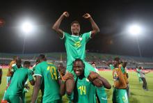 Senegal's Moussa Wague and Henri Saivet celebrate after the match. PHOTO BY REUTERS/Suhaib Salem