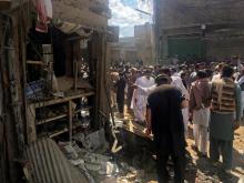 Residents gather near a damaged shop in a market after a blast in Parachinar, Pakistan. PHOTO BY REUTERS/Stringer