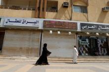 A saudi woman walks next to closed shops in Riyadh, Saudi Arabia, July 12, 2018. PHOTO BY REUTERS/Faisal Al Nasser