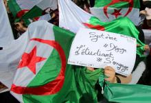 Demonstrators hold flags and banners during anti government protests in Algiers, Algeria April 23, 2019. The banner reads "Government go away - students take over". PHOTO BY REUTERS/Ramzi Boudina