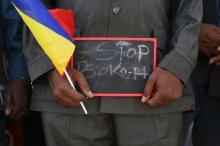 A man holds a sign that reads "Stop Boko Haram" at a rally to support Chadian troops heading to Cameroon to fight Boko Haram, in N'djamena, January 17, 2015. PHOTO BY REUTERS/Emmanuel Braun