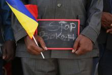 A man holds a sign that reads "Stop Boko Haram" at a rally to support Chadian troops heading to Cameroon to fight Boko Haram, in Ndjamena, January 17, 2015. PHOTO BY REUTERS/Emmanuel Braun