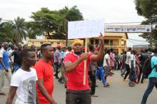 A man holds up a sign, which reads: "Faure must go", during an opposition protest calling for the immediate resignation of President Faure Gnassingbe in Lome, Togo, September 6, 2017. PHOTO BY REUTERS/Noel Kokou Tadegnon