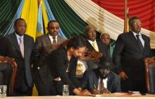 South Sudan's President Salva Kiir (seated) signs a peace agreement in South Sudan's capital Juba, August 26, 2015. PHOTO BY REUTERS/Jok Solomun