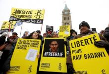 Ensaf Haidar (C) takes part in a demonstration calling for the release of her husband, Raif Badawi, on Parliament Hill in Ottawa, January 29, 2015. PHOTO BY REUTERS/Chris Wattie