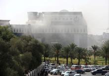 Smoke rises form the headquarters of Libya's state National Oil Corporation (NOC) in Tripoli after three militants attacked it on September 10, 2018. PHOTO BY REUTERS/Hani Amara