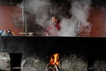 Jiejie Li, the wife of fisherman Sun Lianxi prepares food on a wood stove in their makeshift dwelling at the Yellow River embankment on the northern outskirts of Zhengzhou, Henan province, China, February 21, 2019. PHOTO BY REUTERS/Thomas Peter