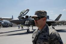 A U.S. soldier stands guard as a Lockheed Martin F-35 Lightning II aircraft is moved, on the eve of the 52nd Paris Air Show at Le Bourget Airport near Paris, France, June 18, 2017. PHOTO BY REUTERS/Pascal Rossignol