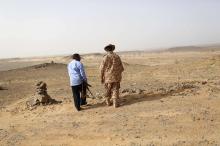 A Libyan soldier (R) and a member of a security unit patrol the desert border between Libya and Algeria