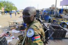 South Sudanese army soldier stands near belongings thrown on the street of Malakal town, 497km (308 miles) northeast of capital Juba, December 30, 2013 after retaking the town from rebel fighters