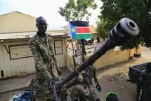 A South Sudan army soldier stands next to a machine gun mounted on a truck in Malakal town, 497km (308 miles) northeast of capital Juba, December 30, 2013 after retaking the town from rebel fighters.  PHOTO BY REUTERS/James Akena