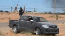 A still image from video released May 17, 2016 shows forces loyal to Libyan unity government celebrating the recapture of Abu Grain, one of the main checkpoints south of the city of Misrata, Libya from Islamic State. PHOTO BY REUTERS